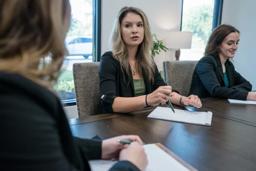 A discussion around the conference table at The Bittick Law Firm