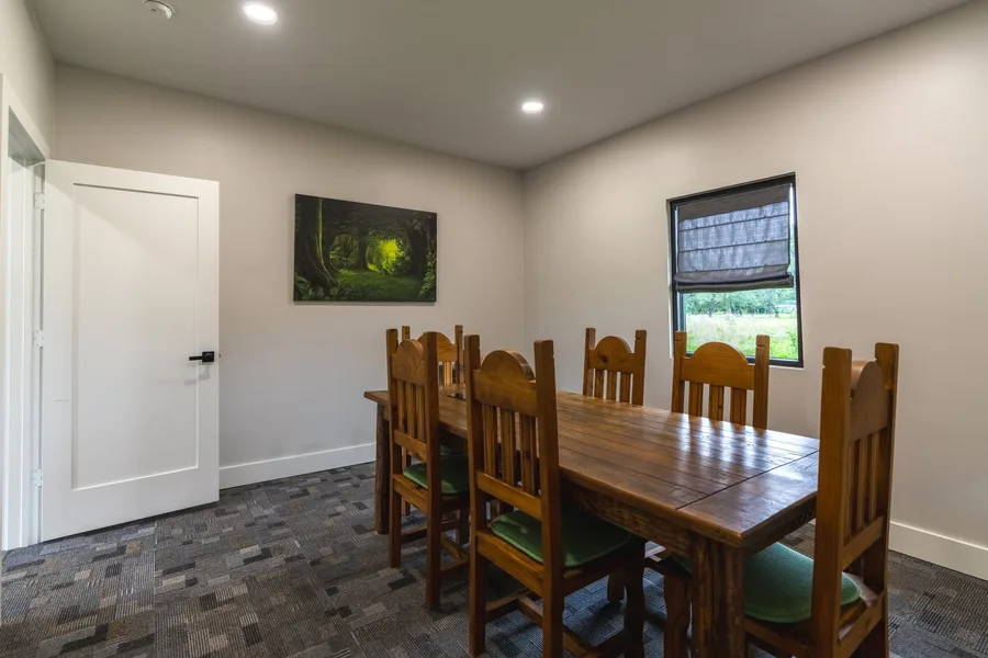 A private meeting room with a wooden table and chairs